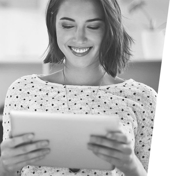 Smiling woman using a digital tablet, representing happy customer experience at iCrack Carmarthen